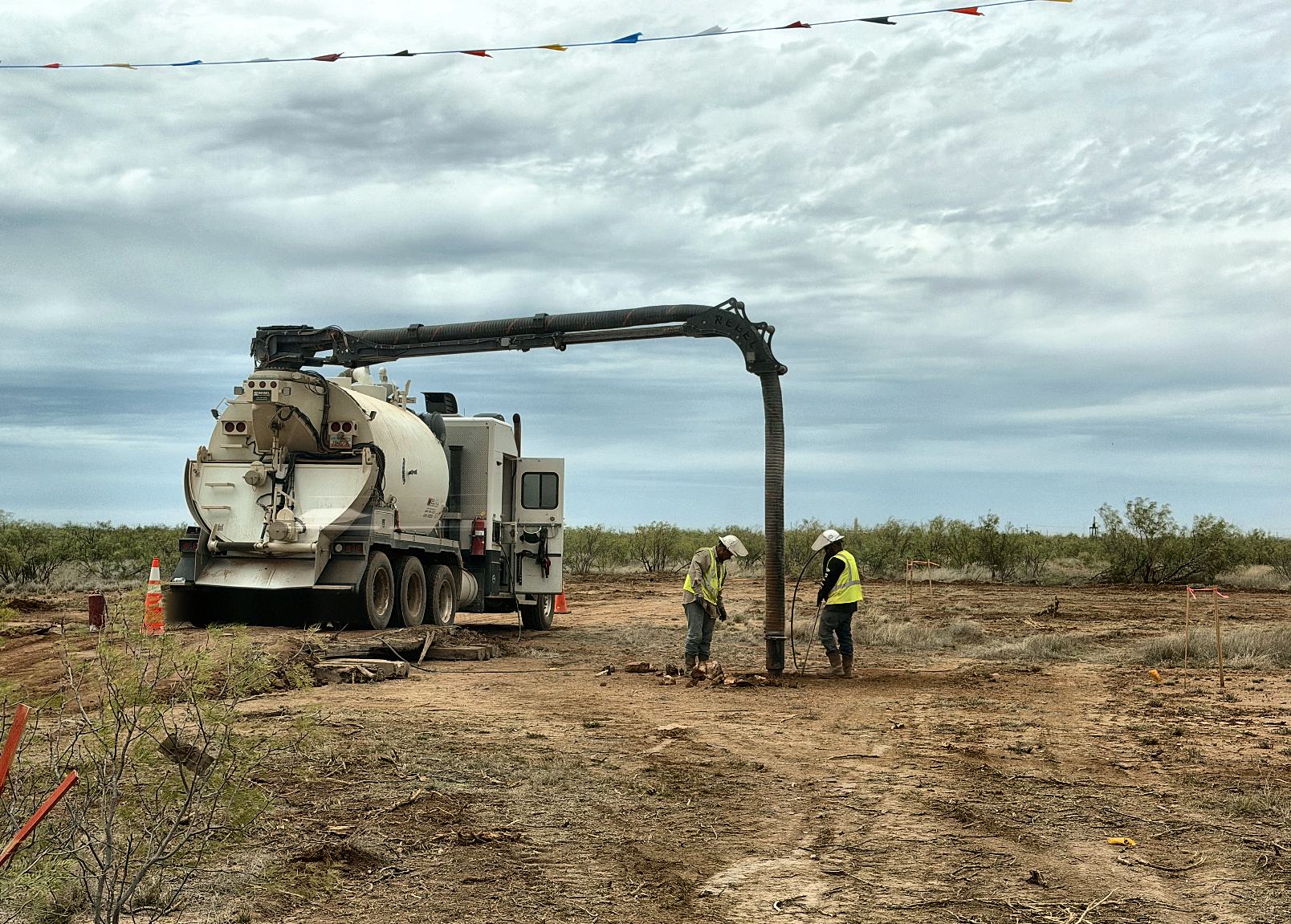 Encore hydrovac truck daylighting around a buried line on a Permian lease