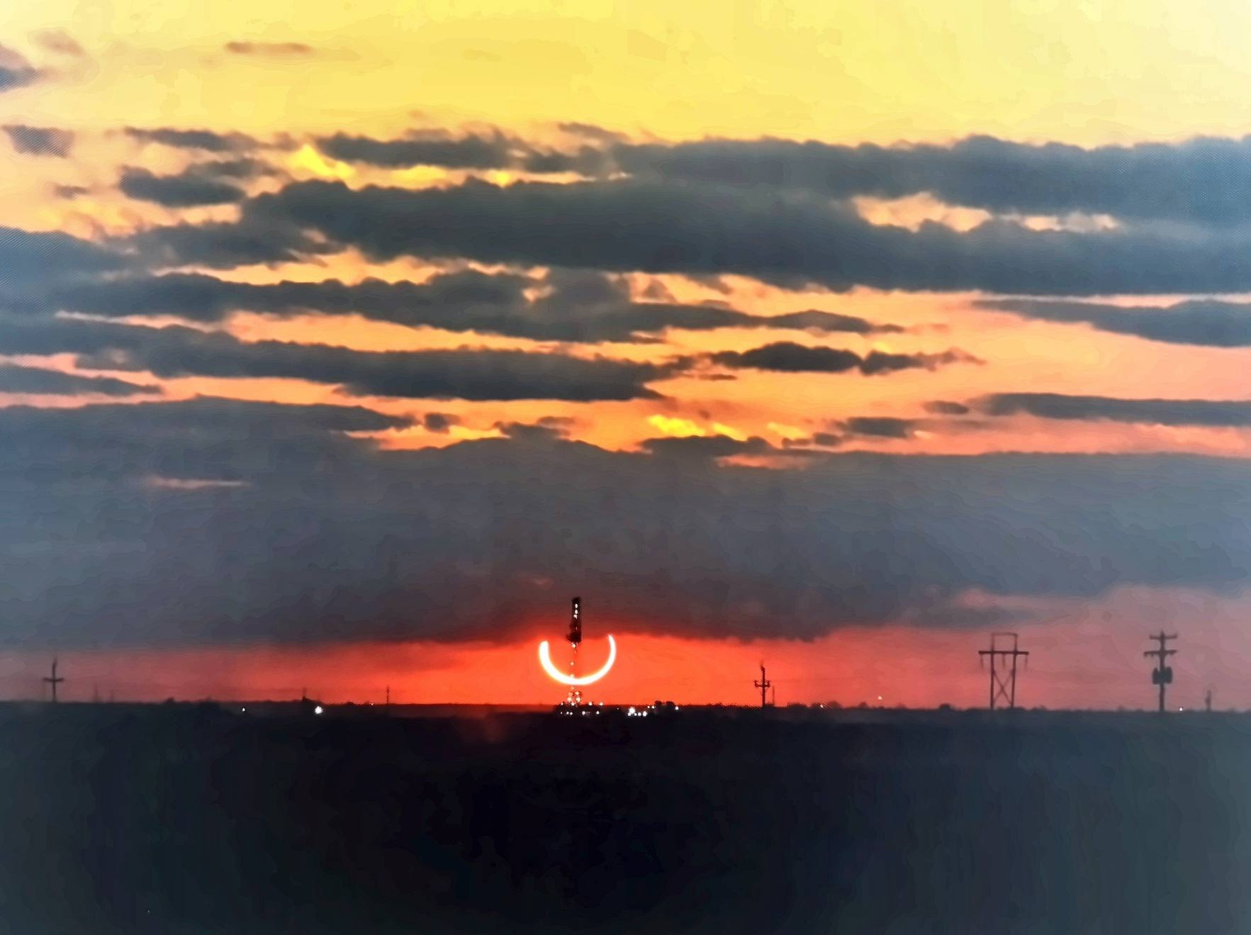 Sunset over the Permian Basin with a drilling rig on the horizon